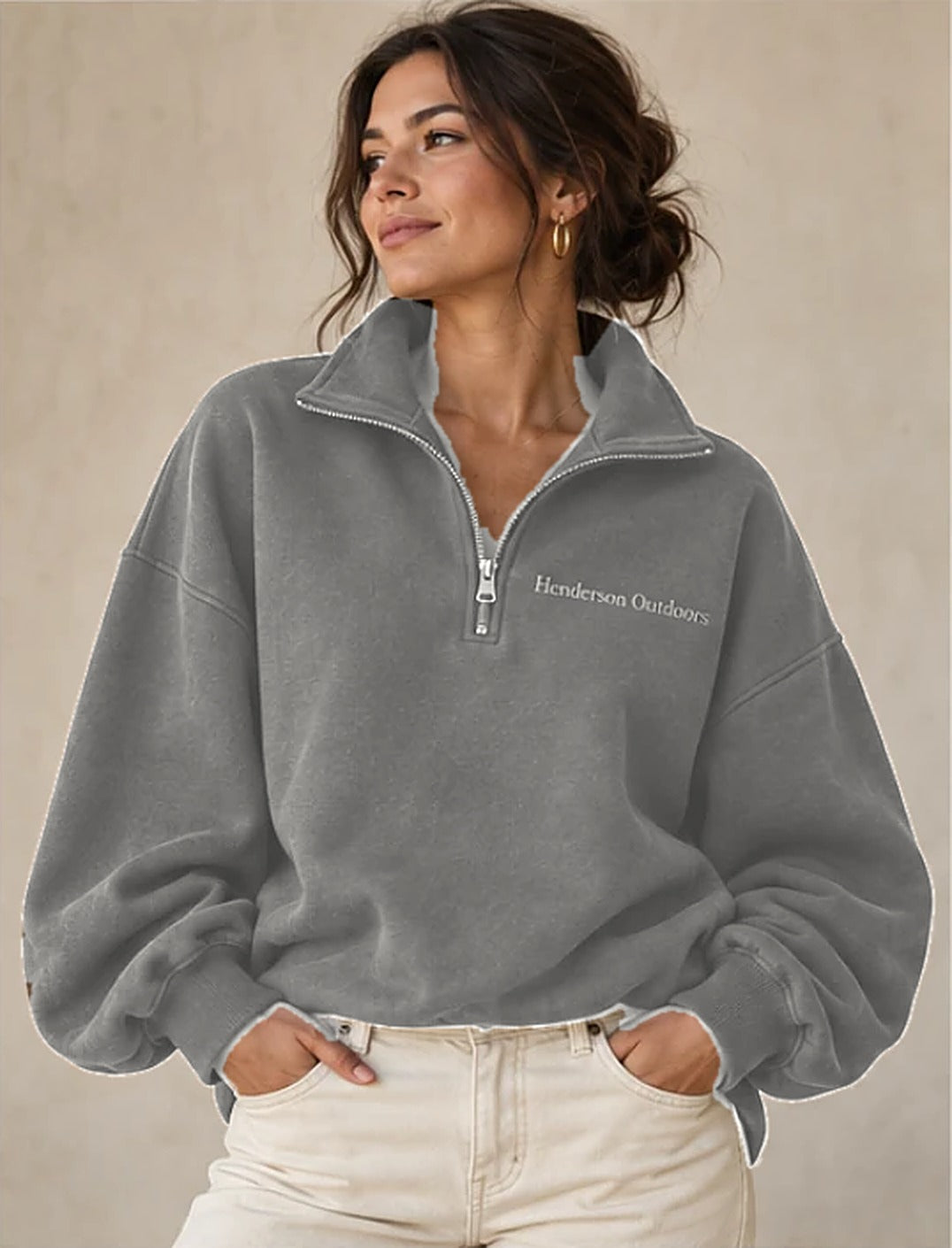 Woman wearing the Henderson Outdoors grey half zip with silver-grey Henderson Outdoors embroidery on the left chest